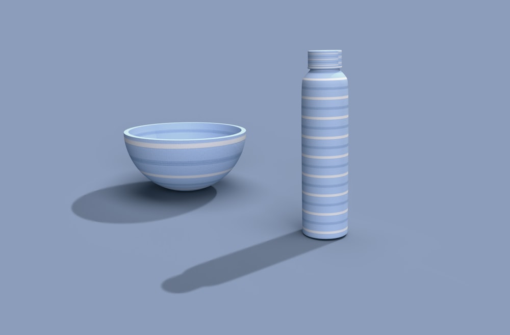 a blue and white bowl next to a blue and white vase