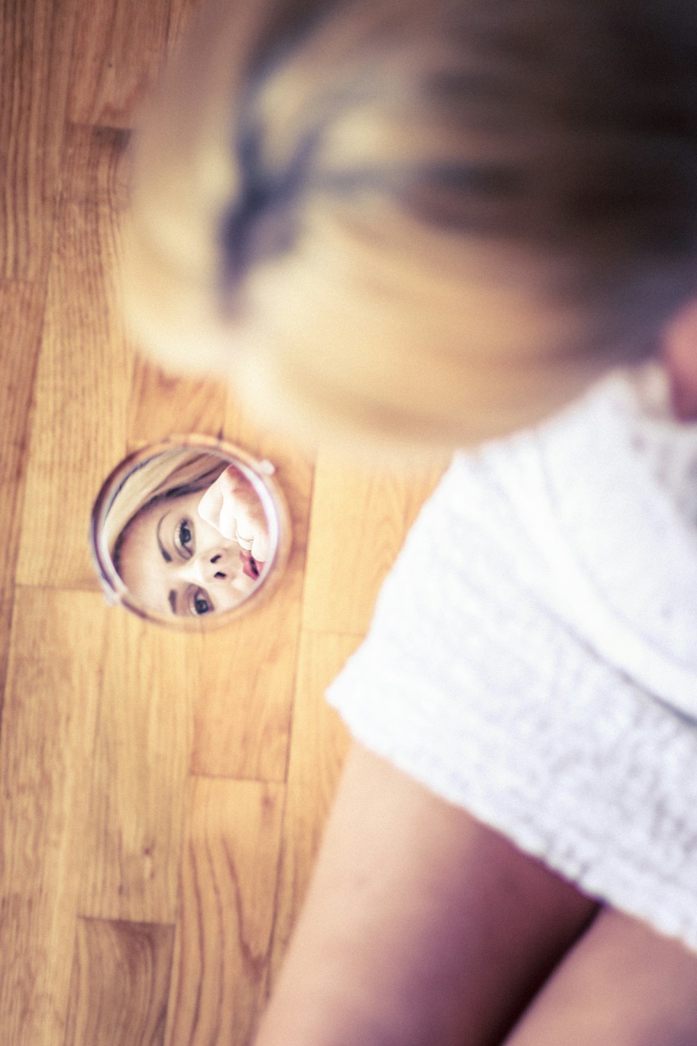 a woman is looking at her reflection in a mirror