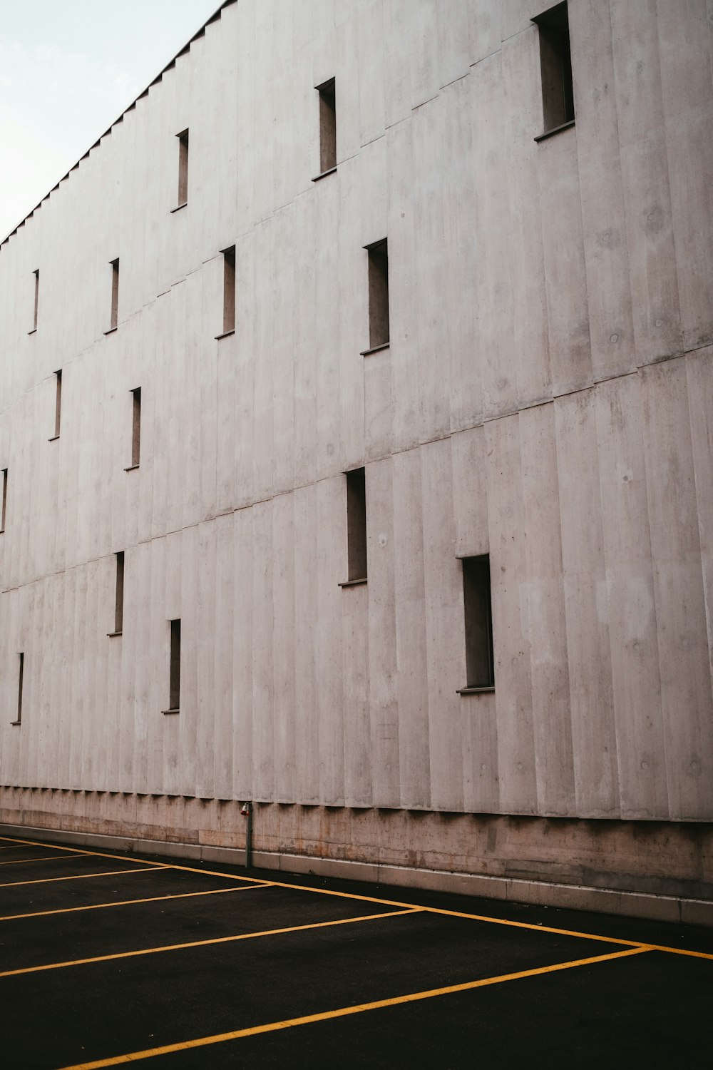 an empty parking lot next to a building