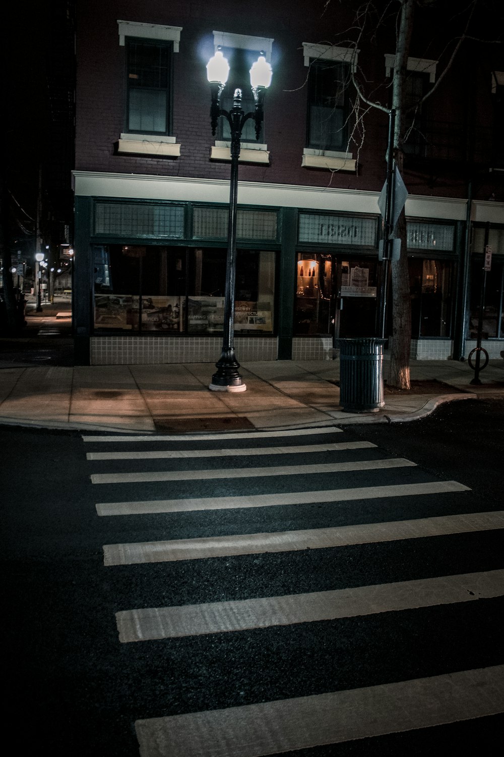 a crosswalk in front of a building at night