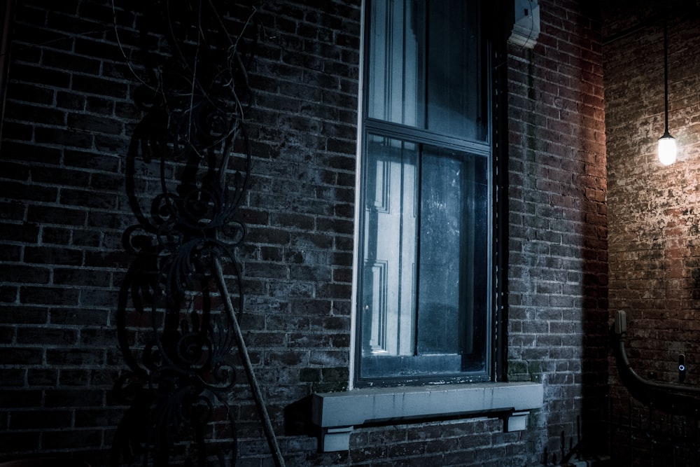 a brick building with a window and a light on