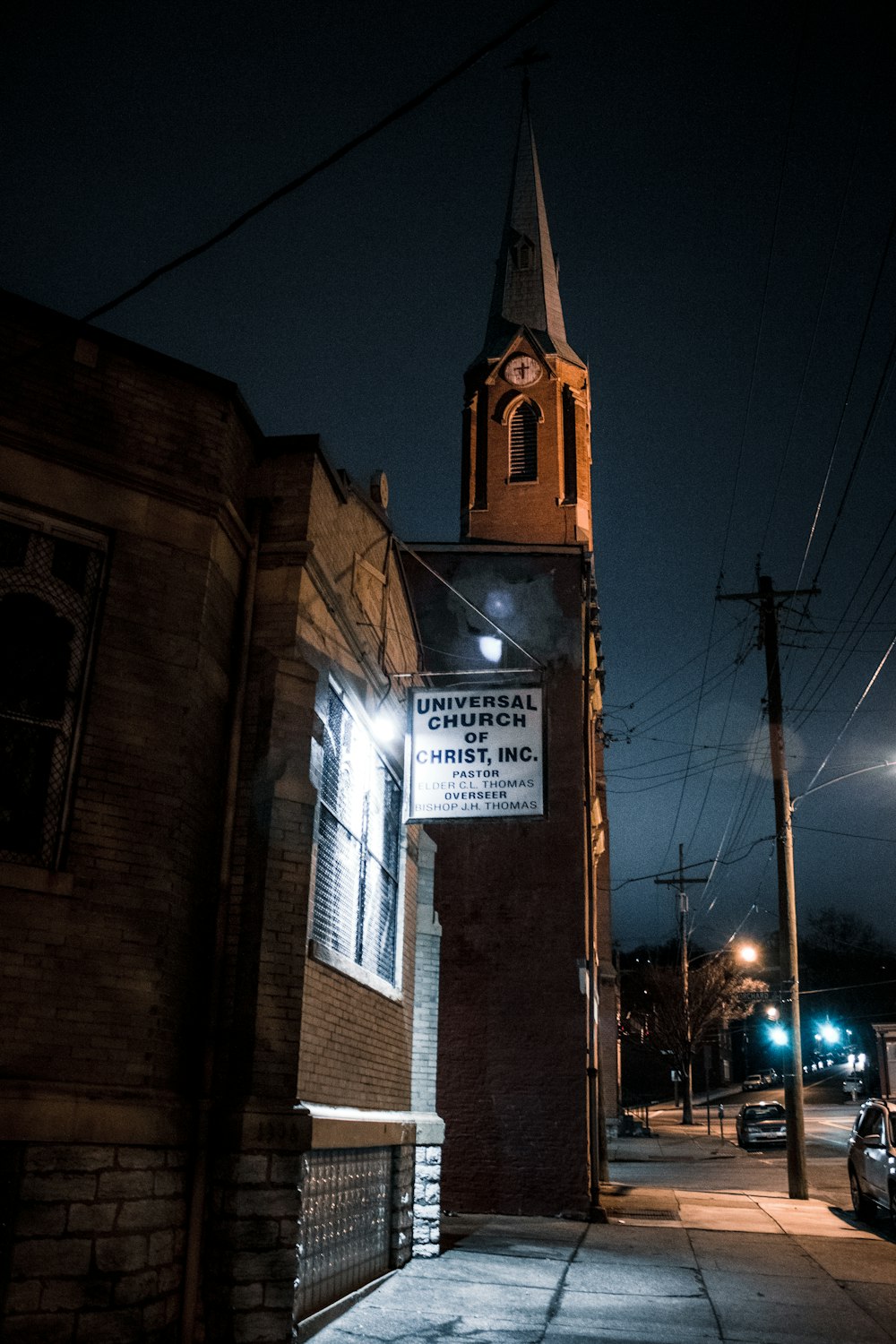 a church steeple lit up at night