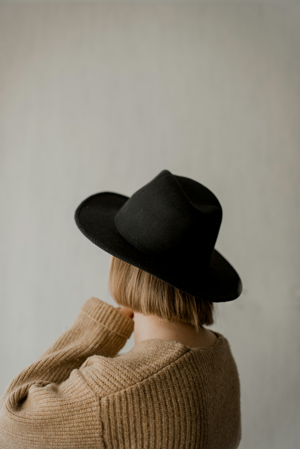 a woman wearing a black hat and sweater