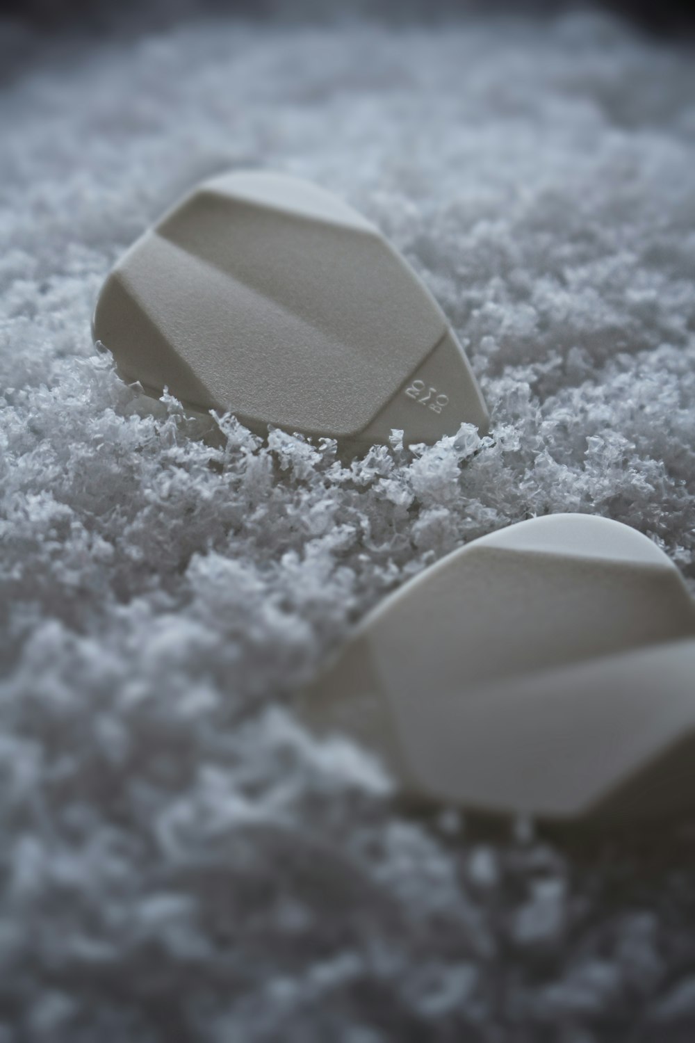 a close up of three paddles on a bed of snow