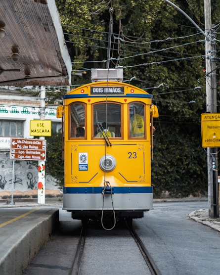 a yellow and blue train traveling down train tracks