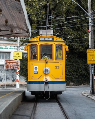 a yellow and blue train traveling down train tracks
