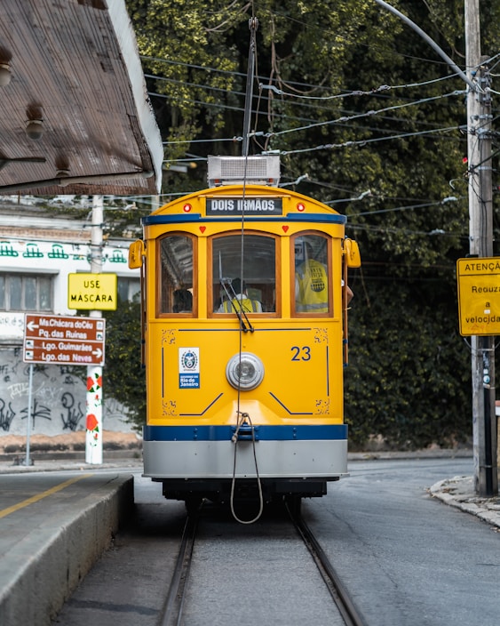 a yellow and blue train traveling down train tracks