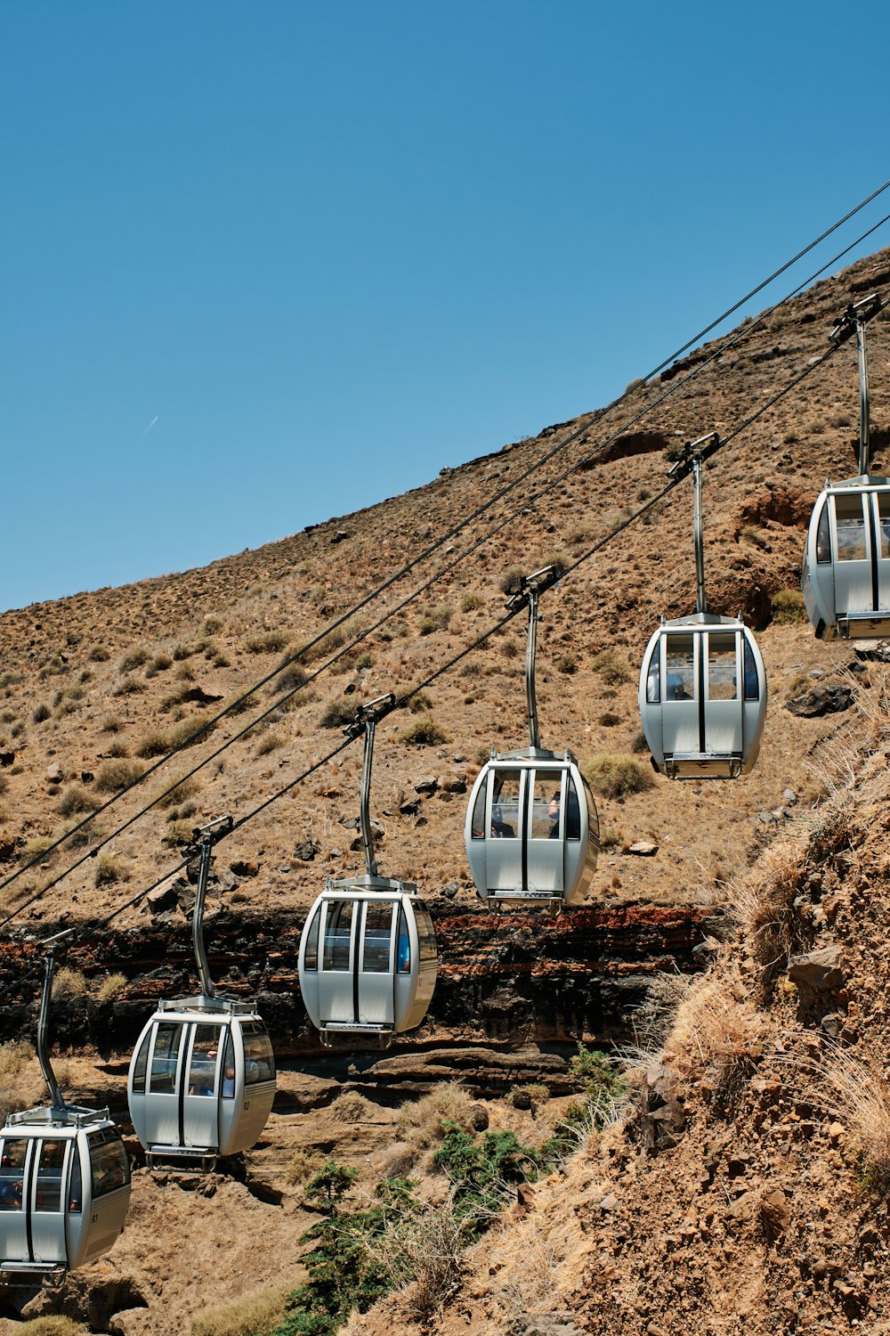 a ski lift going up a hill on a clear day