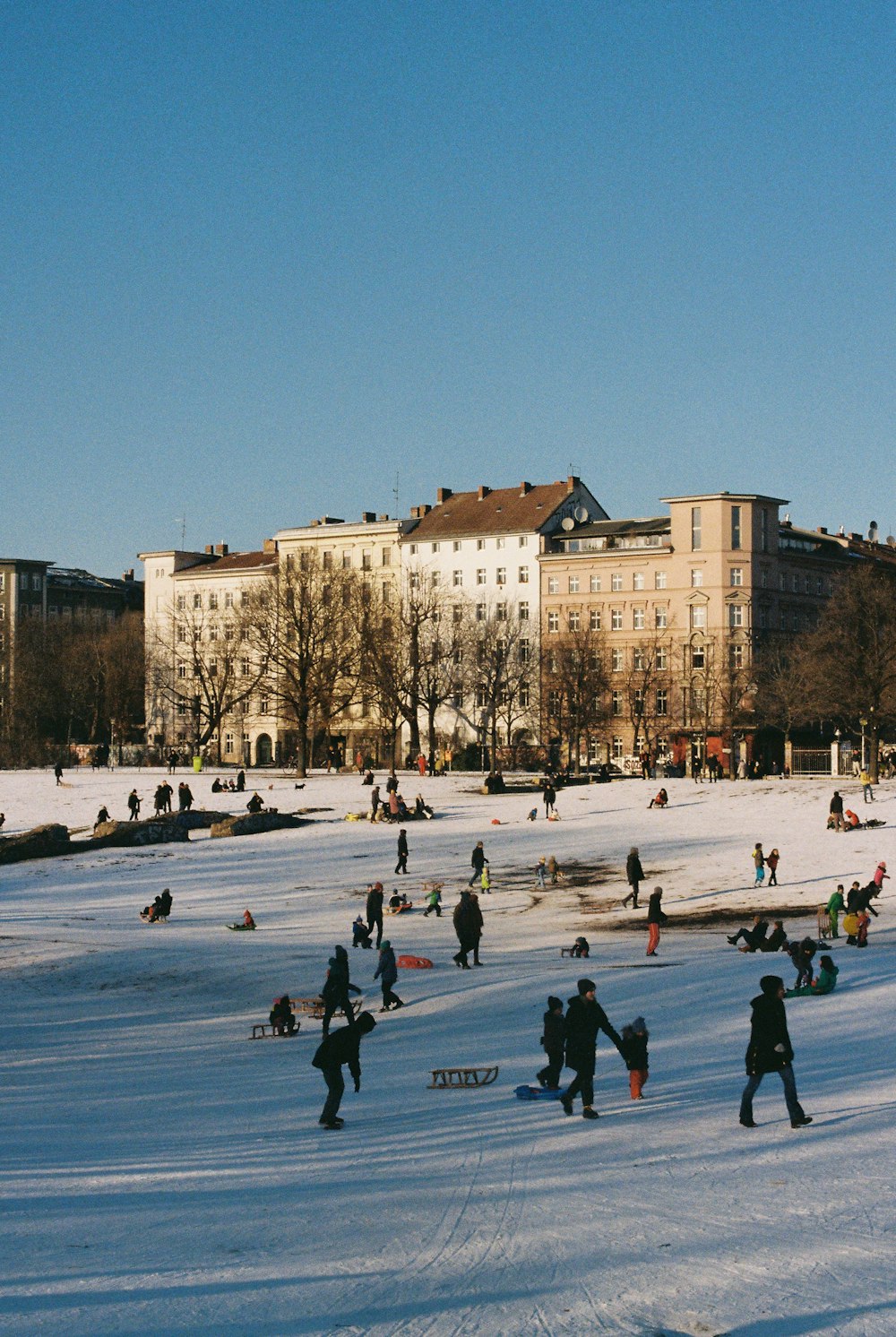 a group of people walking across a snow covered field