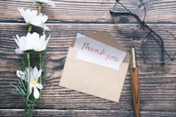 A collection of handwritten thank-you notes and testimonials from clients displayed on a wooden table.