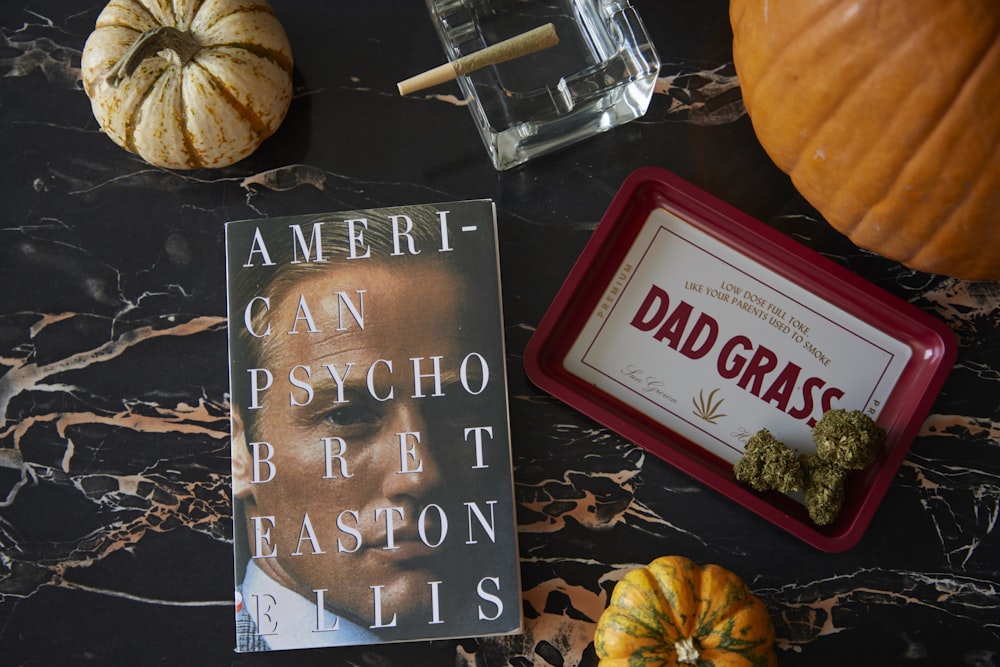 a book sitting on top of a table next to pumpkins