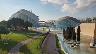 A sleek tech campus with glass buildings and solar panels, surrounded by landscaped gardens.