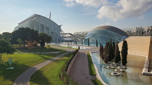 An elegant commercial complex with glass facades and landscaped surroundings.