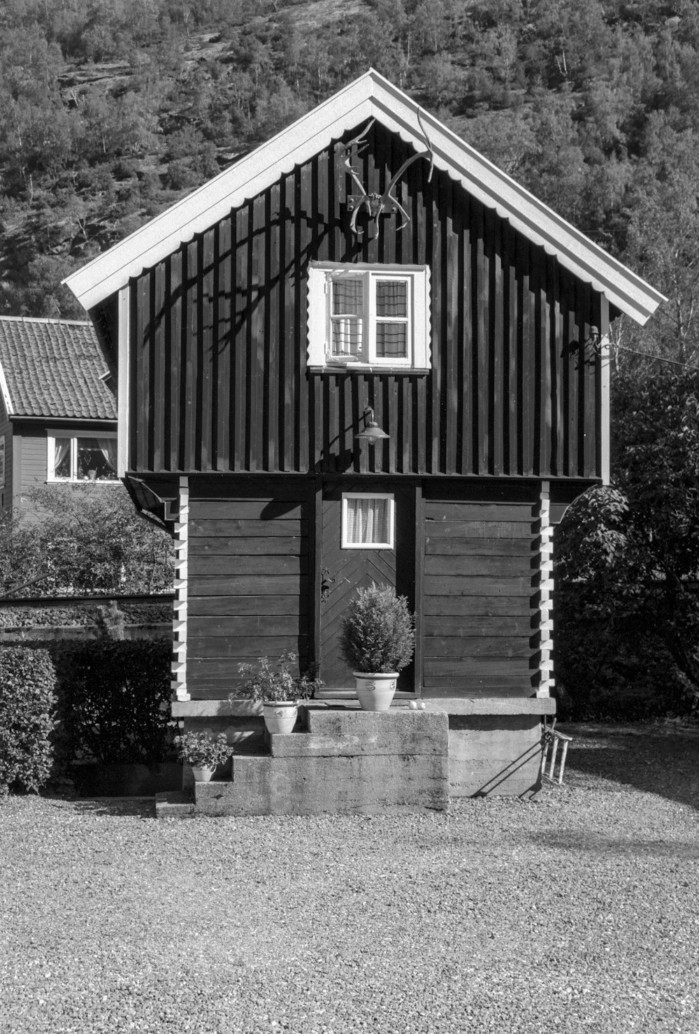 a black and white photo of a small house