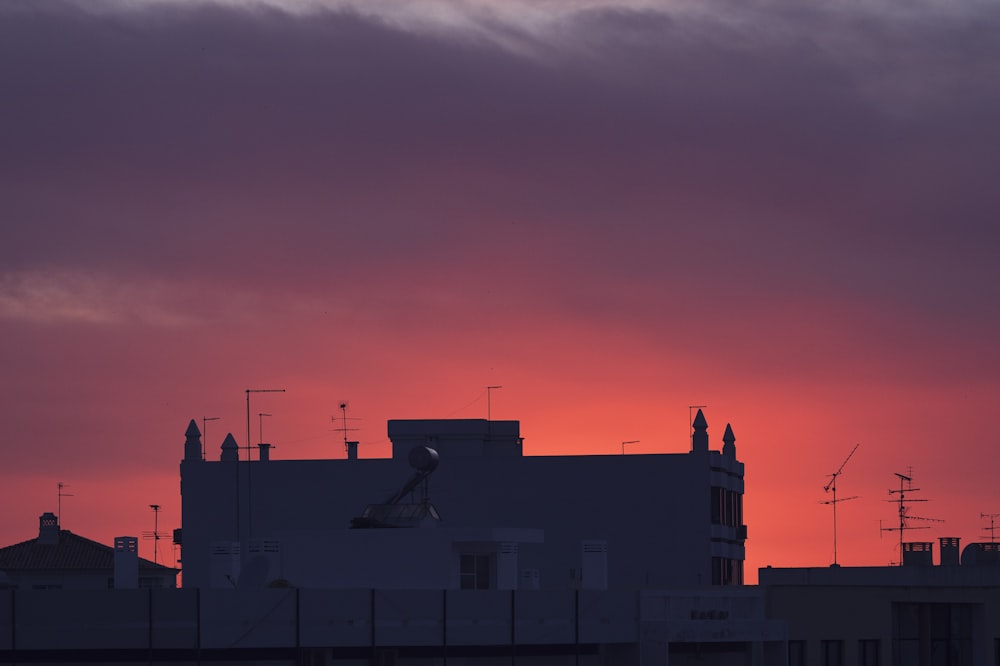 the sun is setting over a city skyline