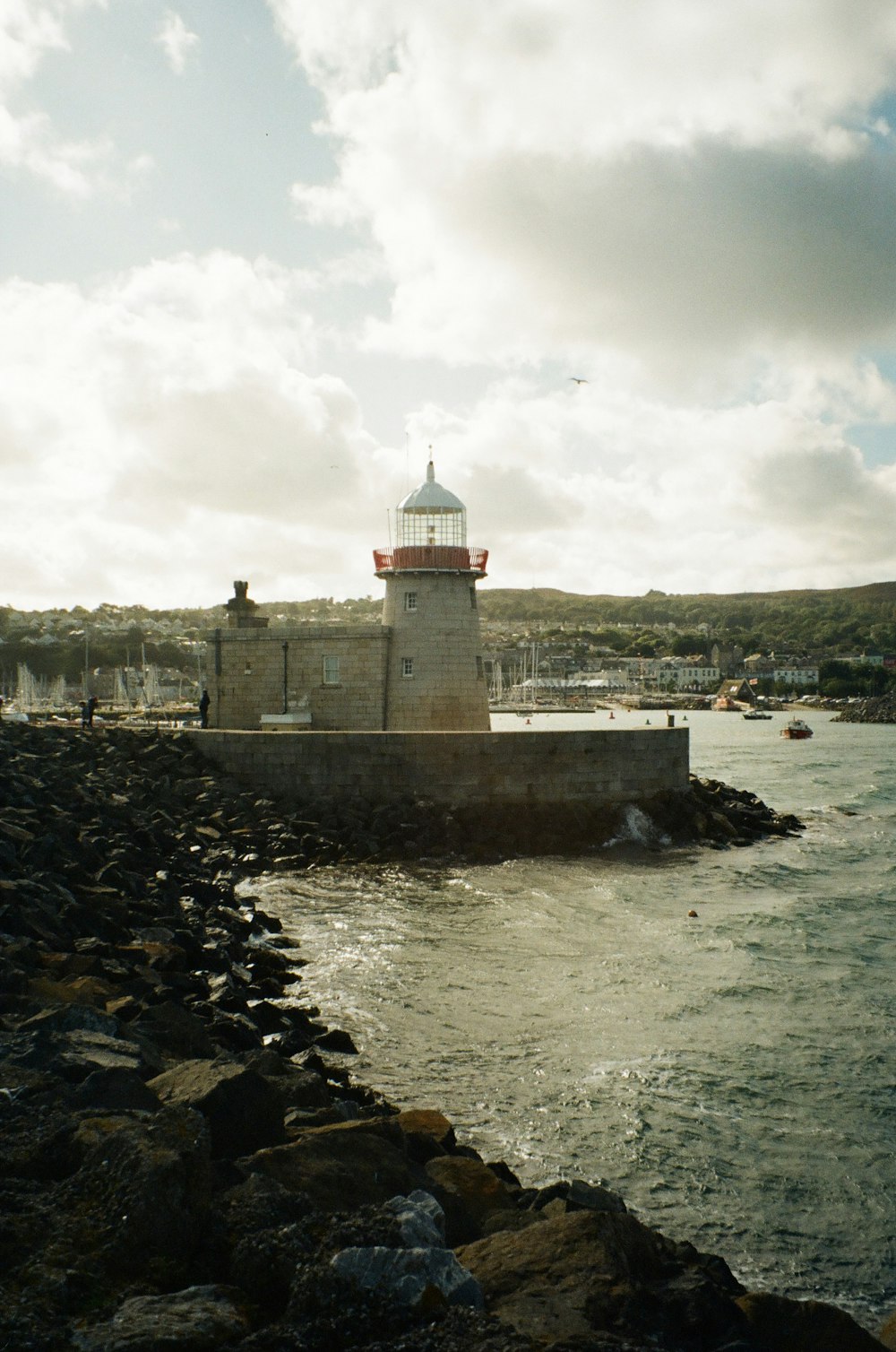 a light house sitting on top of a rocky shore