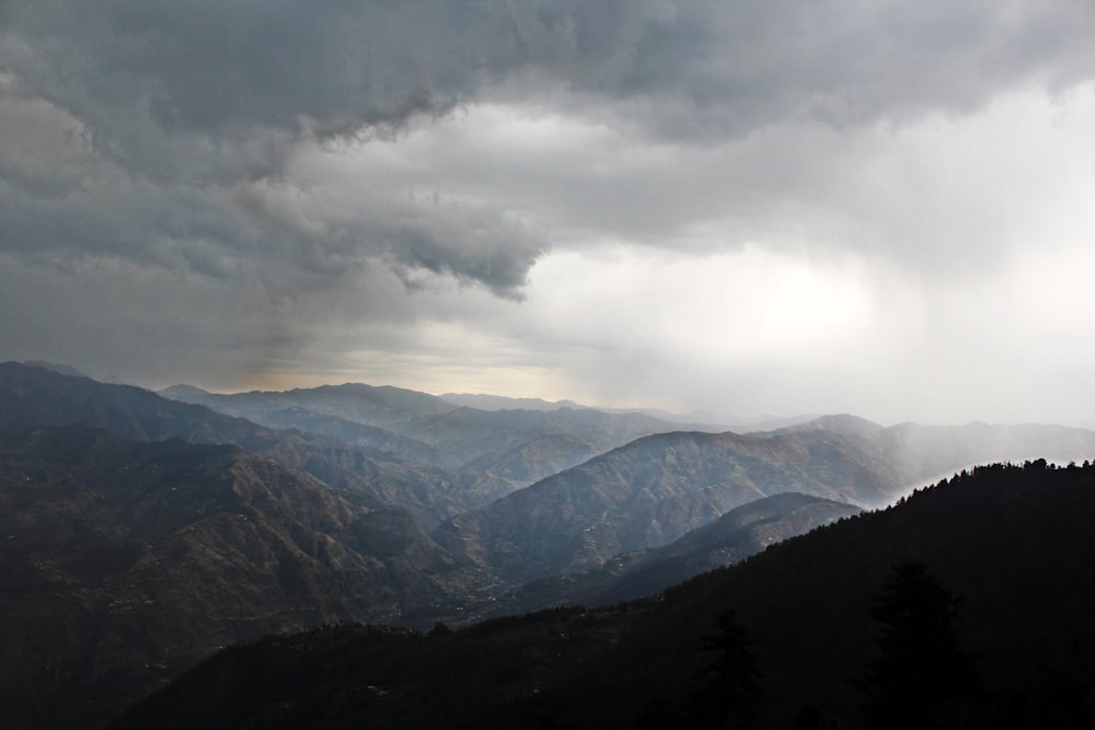 a view of a mountain range under a cloudy sky