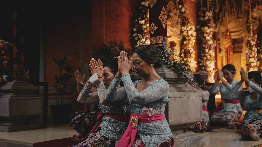 a group of women sitting on top of a floor next to each other,