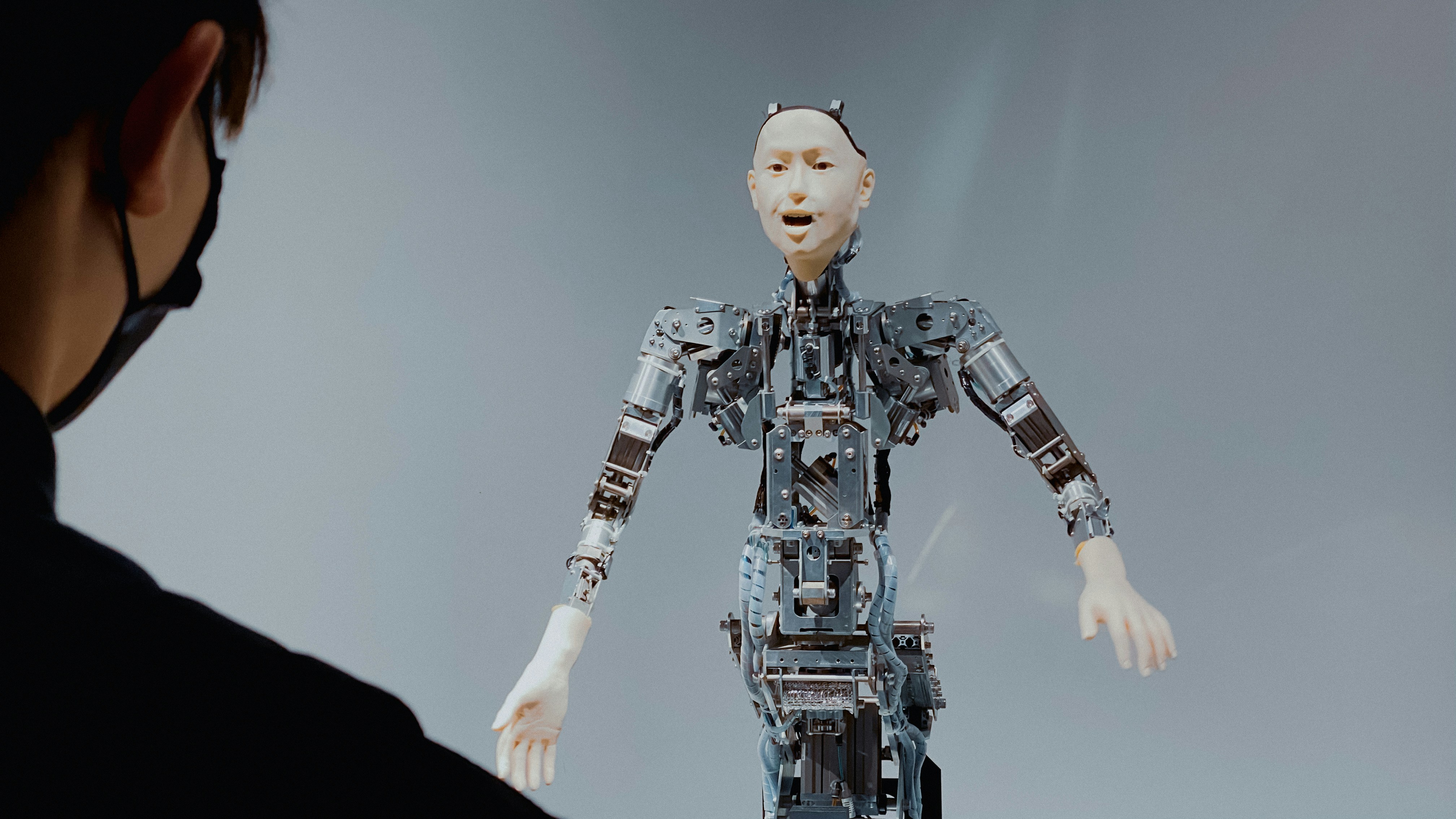 Branimo blog image: woman looking at a flying robot, representing technology and innovation.