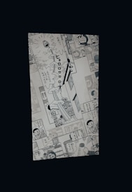 A manga page featuring various panels with illustrations and Japanese text. Characters include a robot cat and a young boy, engaged in dialogue and activities.