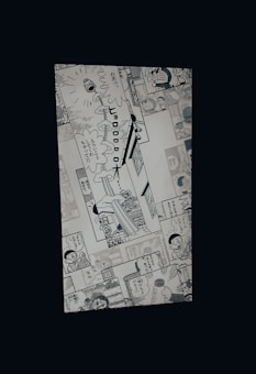 A manga page featuring various panels with illustrations and Japanese text. Characters include a robot cat and a young boy, engaged in dialogue and activities.