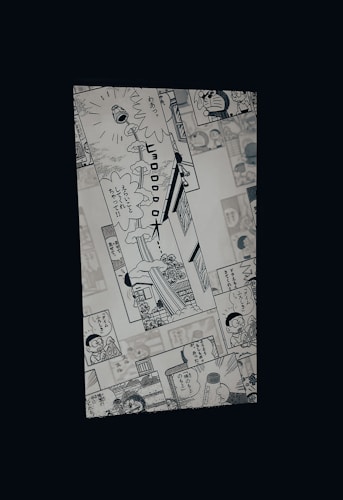 A manga page featuring various panels with illustrations and Japanese text. Characters include a robot cat and a young boy, engaged in dialogue and activities.