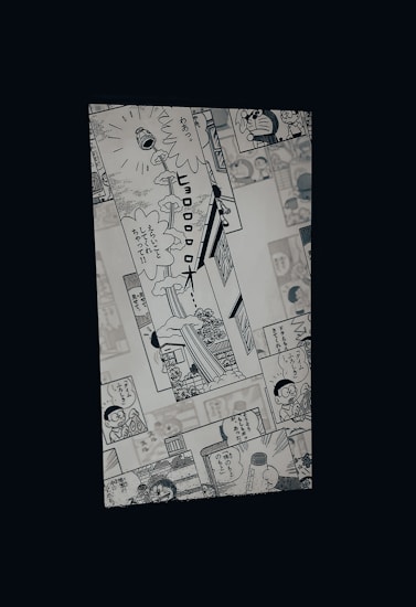 A manga page featuring various panels with illustrations and Japanese text. Characters include a robot cat and a young boy, engaged in dialogue and activities.