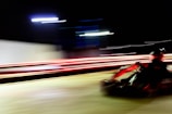 Dynamic shot of karts speeding around a sharp corner with motion blur.