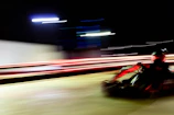 Dynamic photo of a kart speeding through a sharp corner, tires gripping the asphalt.