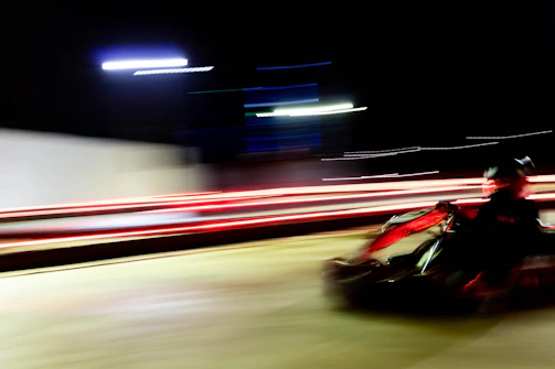 Dynamic photo of a kart speeding through a sharp corner, tires gripping the asphalt.
