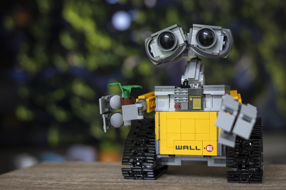 A robot made out of legos sitting on a table photo – Free Robot Image on  Unsplash