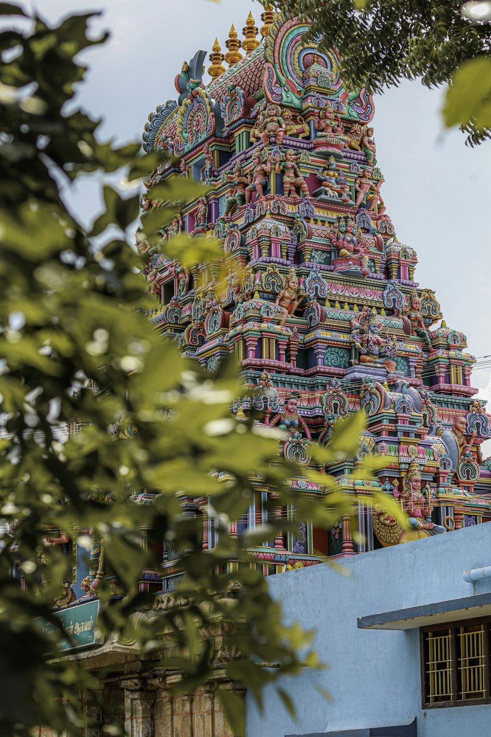 a very tall colorful building with a clock on it's side