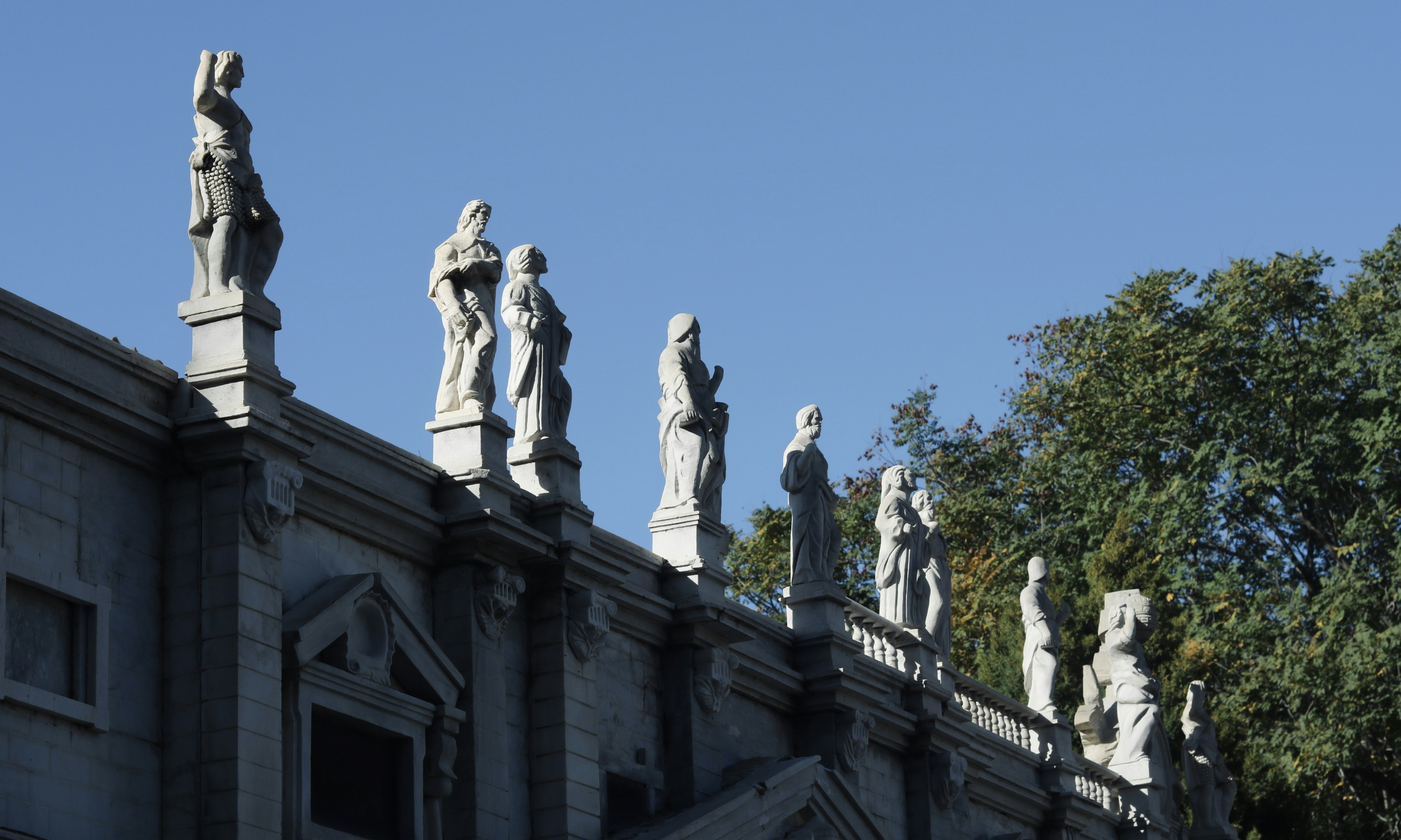 a group of statues on top of a building