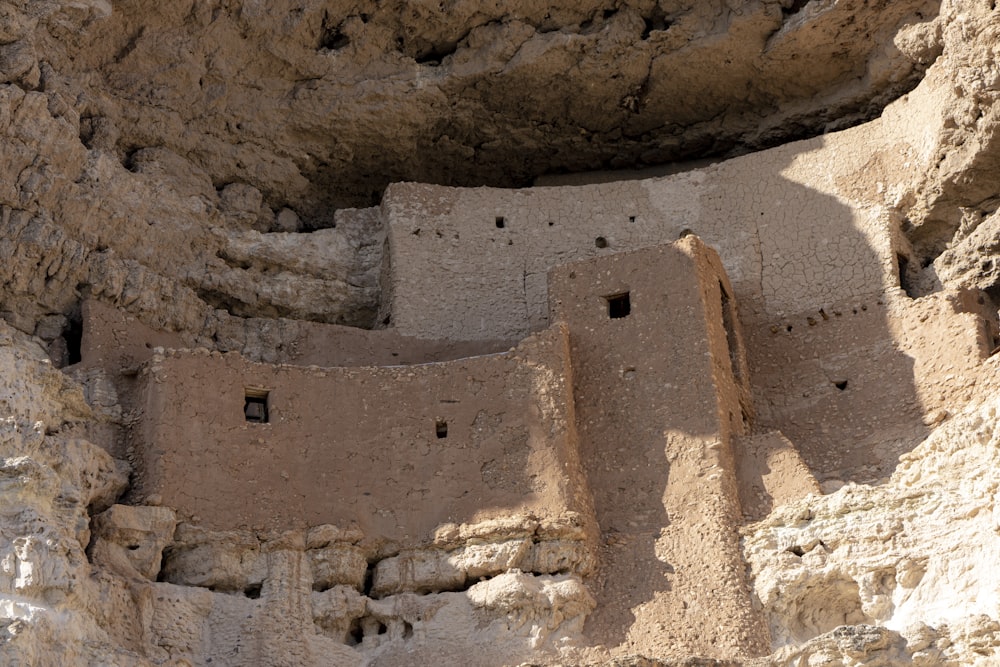 a stone building built into the side of a mountain