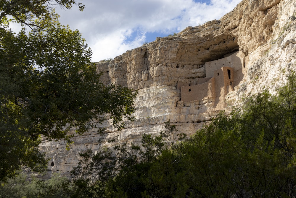 a cliff with a cave in the middle of it