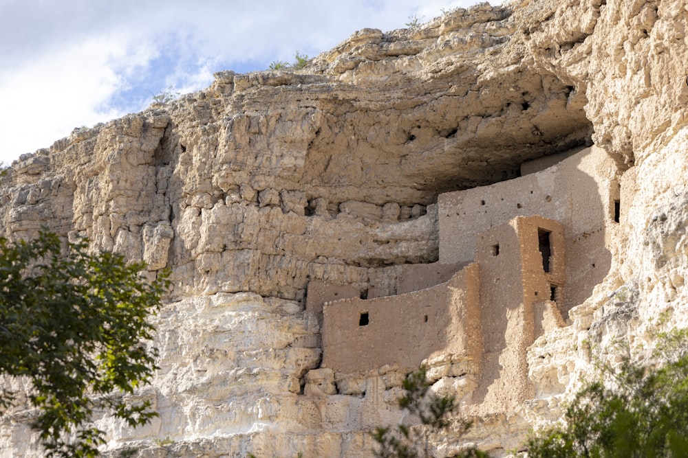 a cliff side with a building built into the side of it