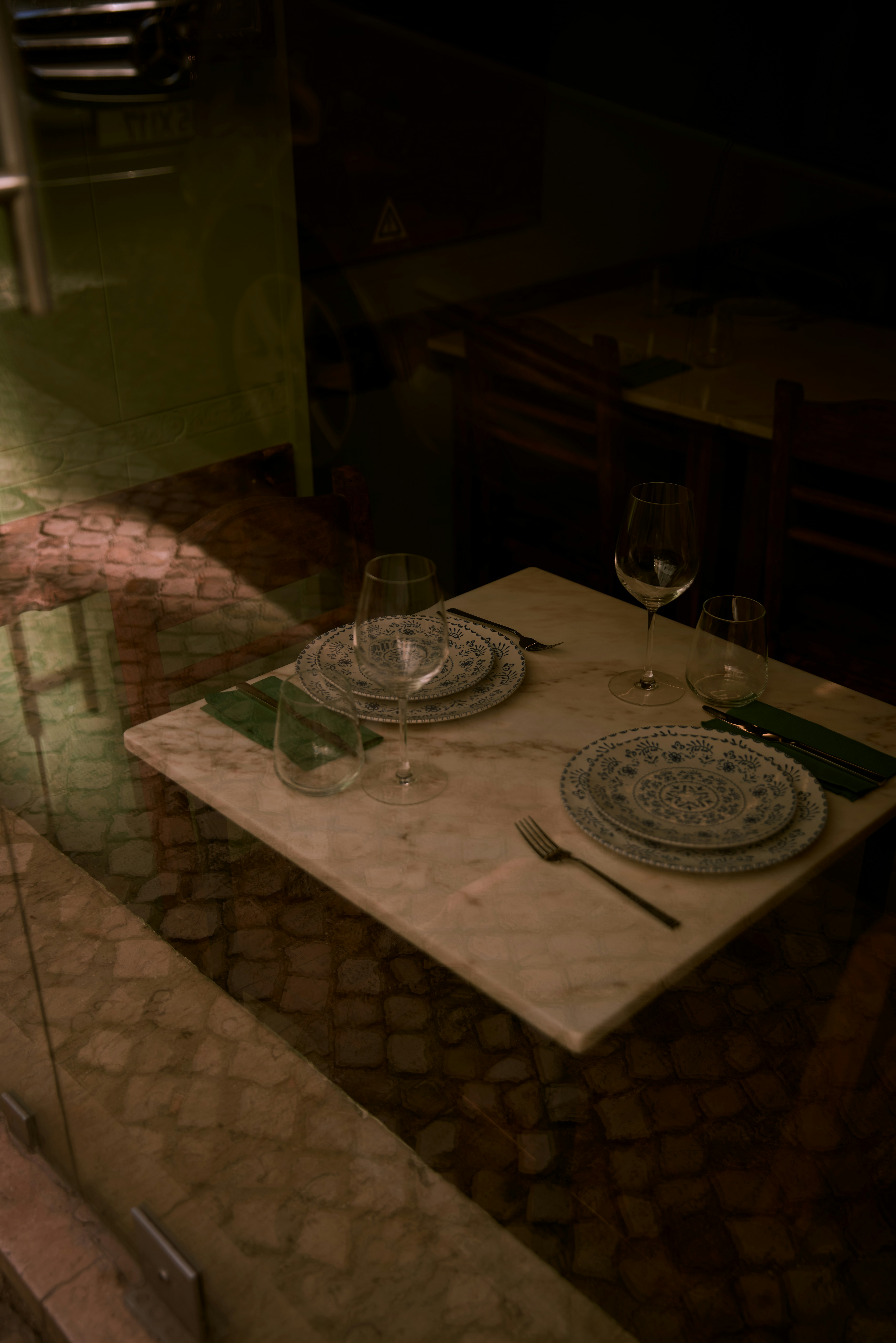 a table with two plates and a wine glass on it