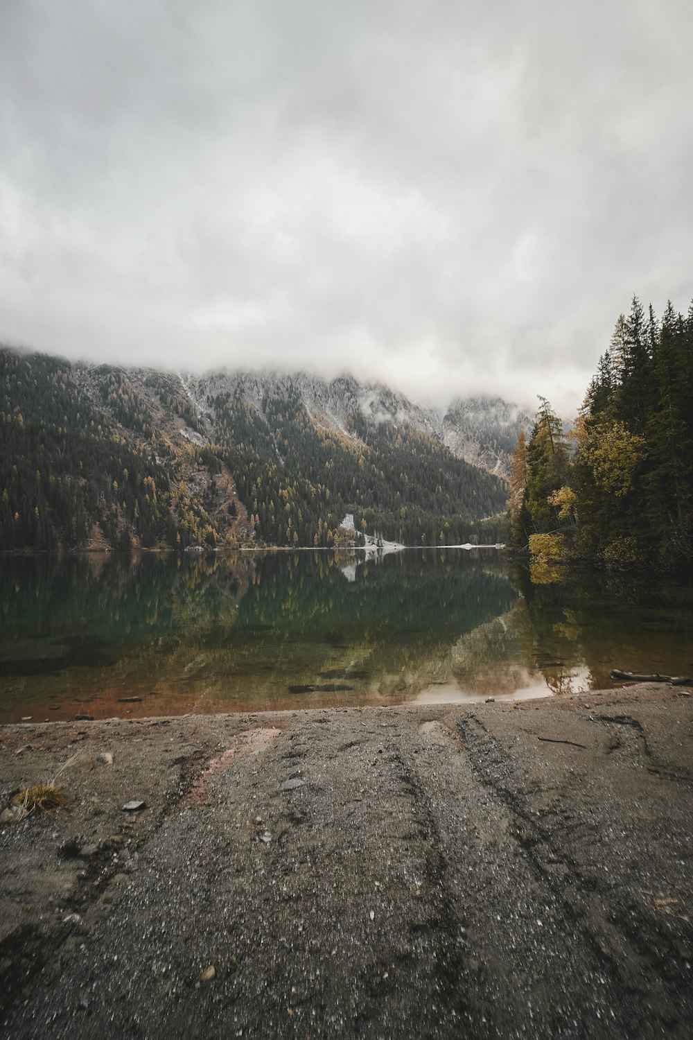 a body of water with mountains in the background