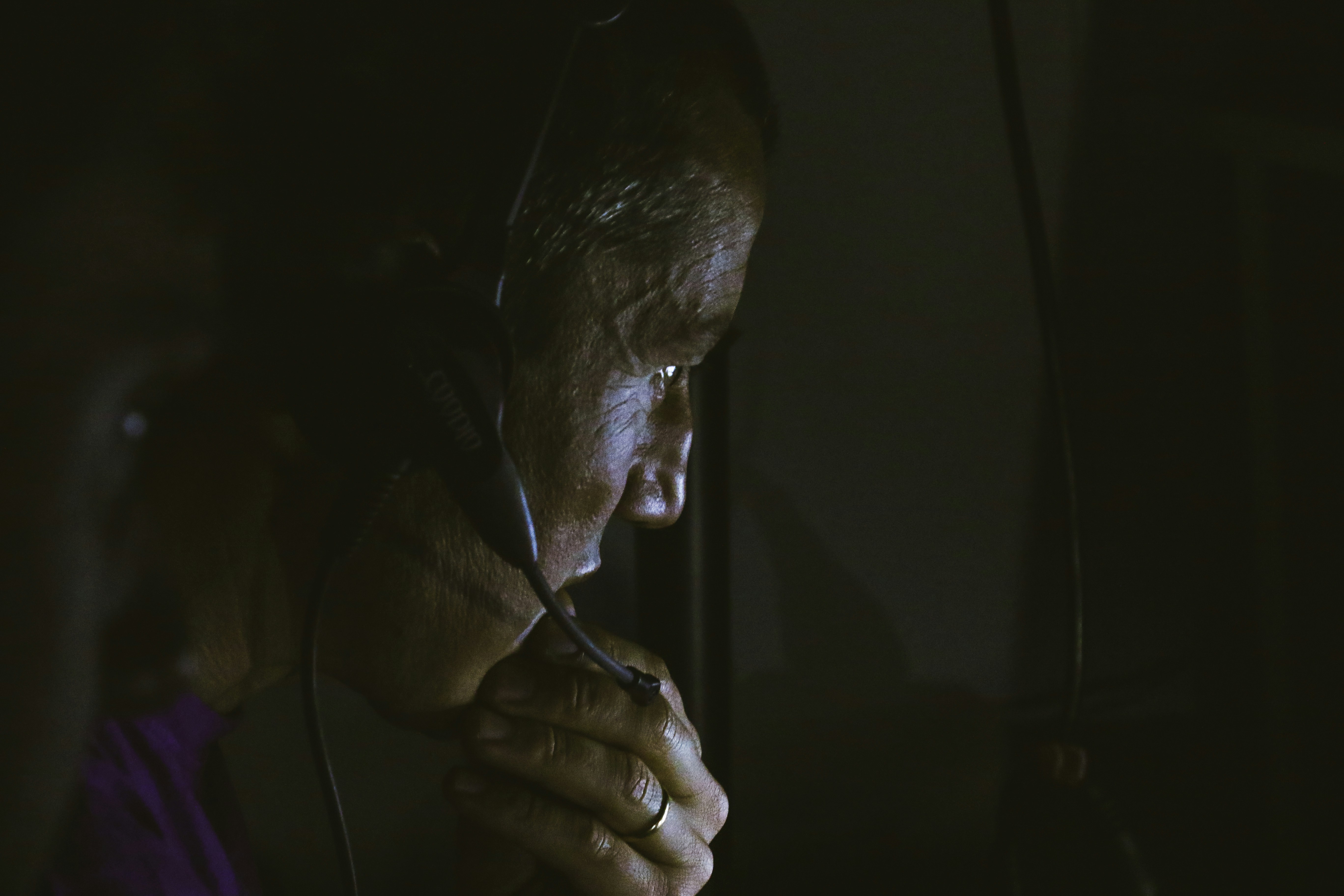 a man with headphones on looking at a computer screen