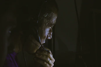 a man with headphones on looking at a computer screen