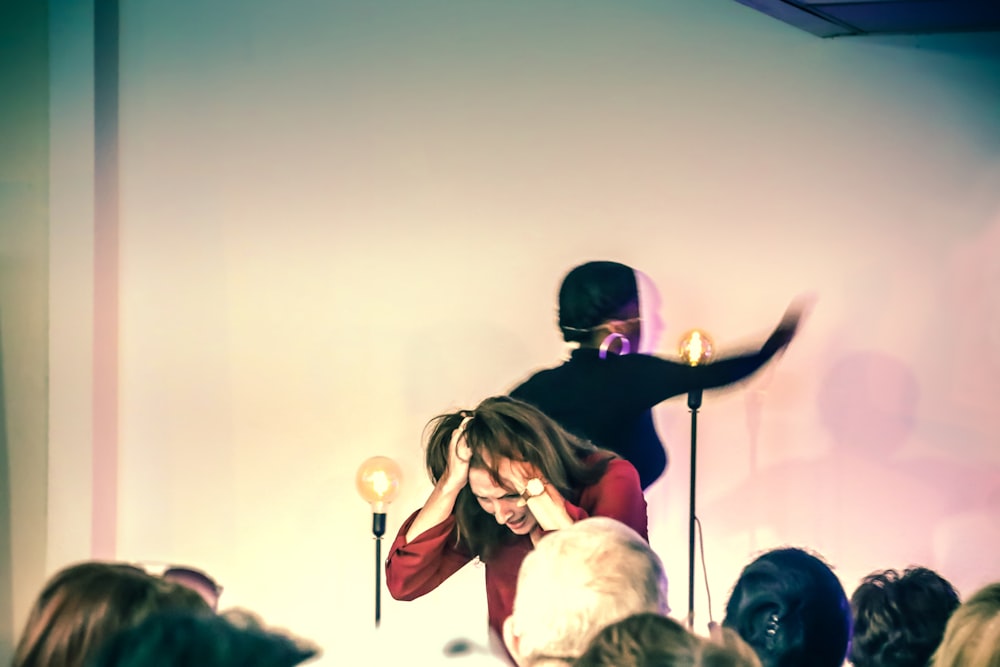 a woman standing on top of a stage next to a microphone