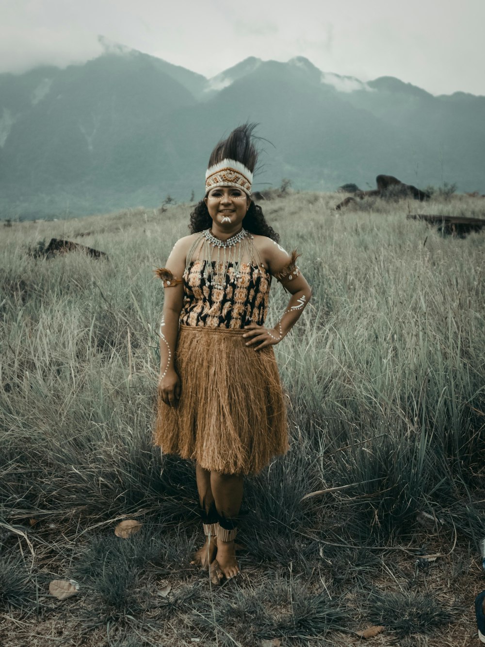 a native american girl standing in a field