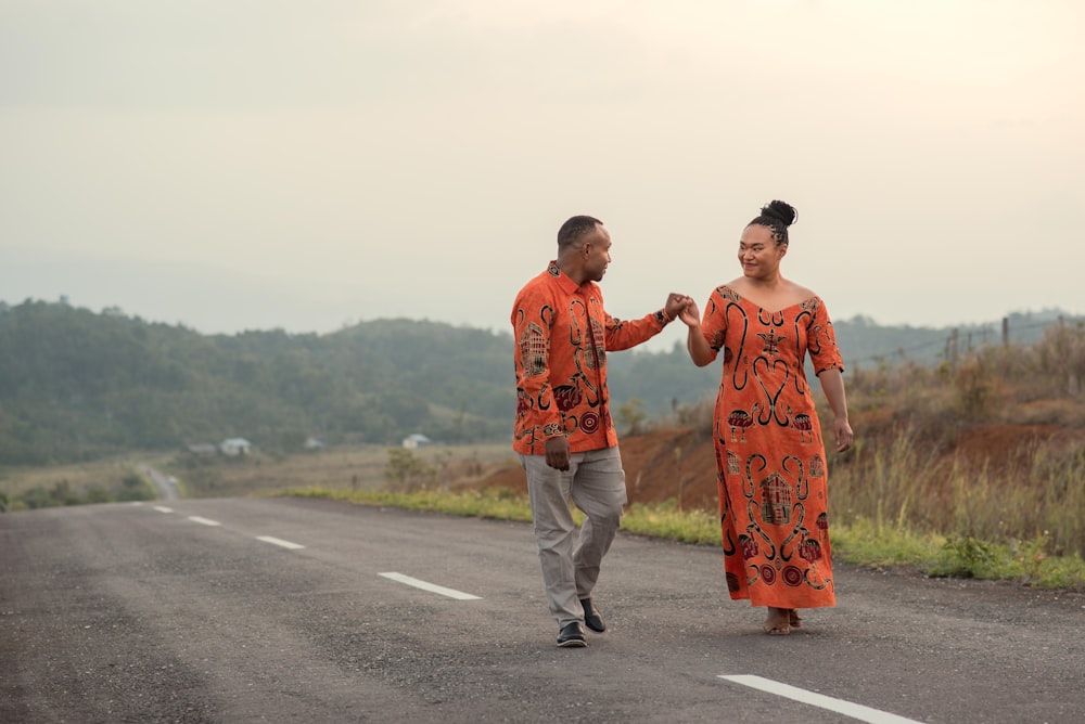 a man and a woman walking down a road