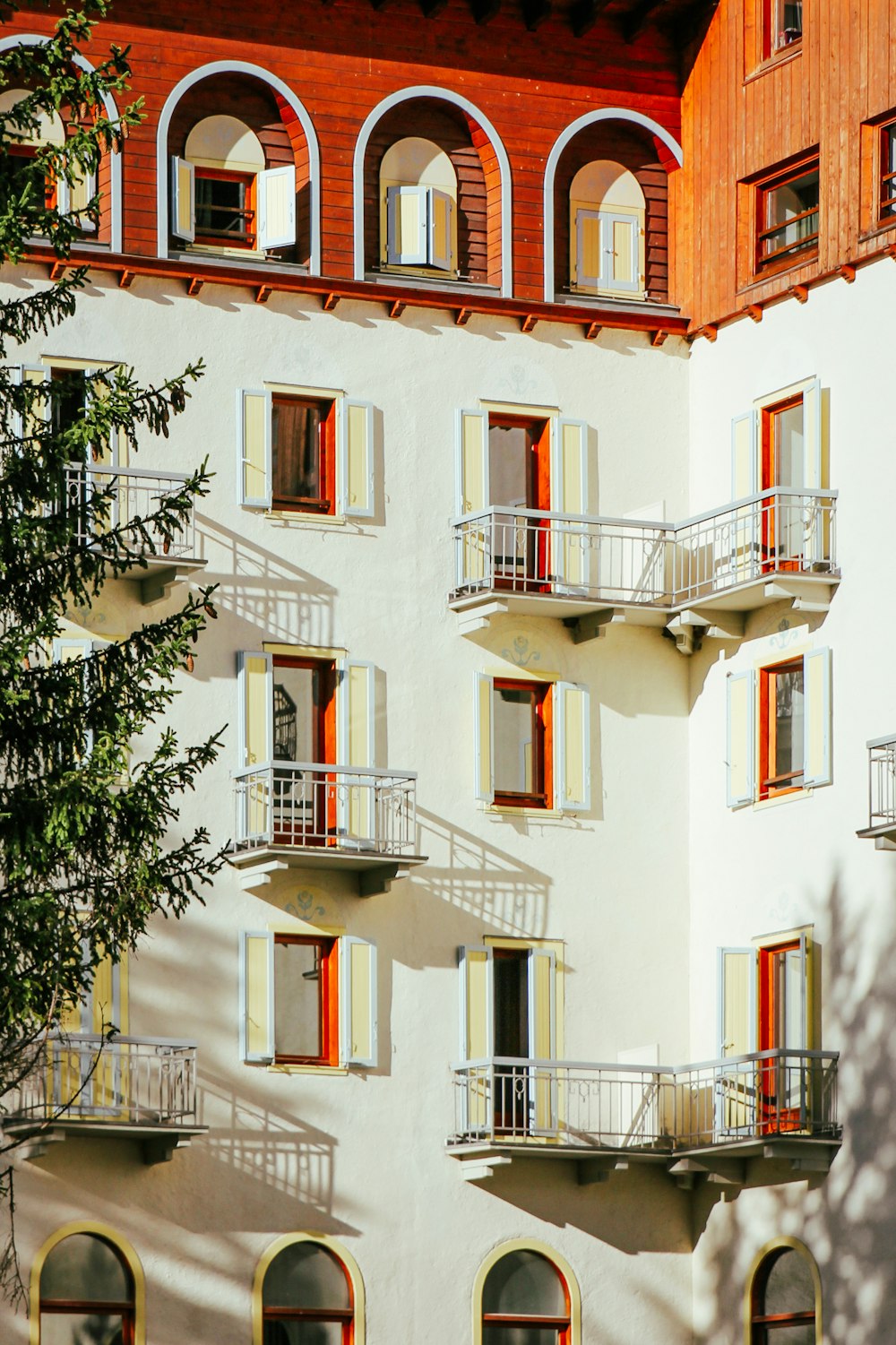 a tall white building with red and yellow windows