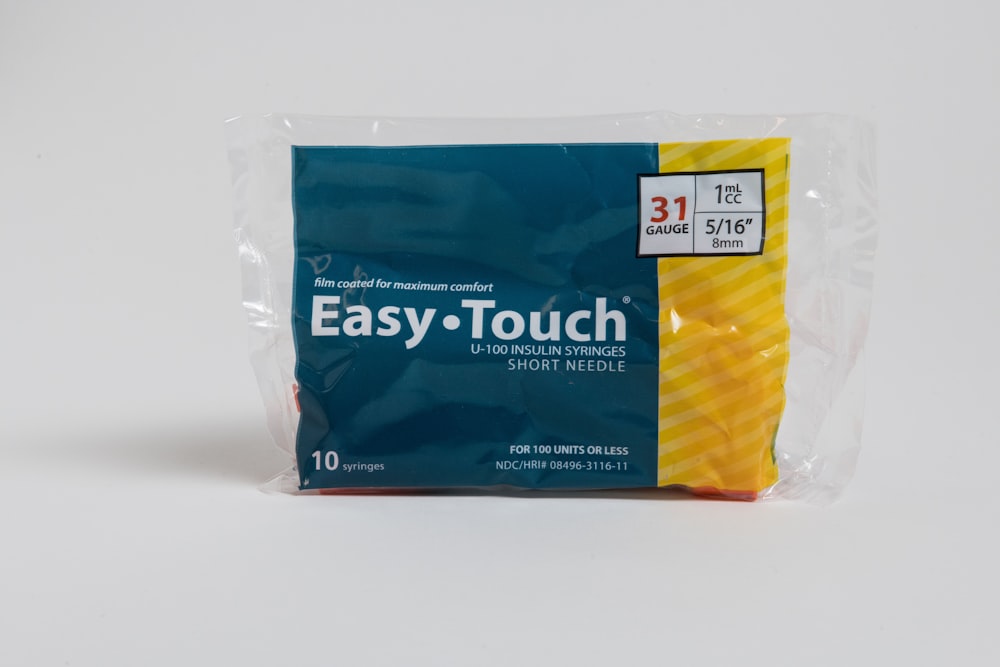 Un paquete de pasta de dientes Easy Touch sobre un fondo blanco