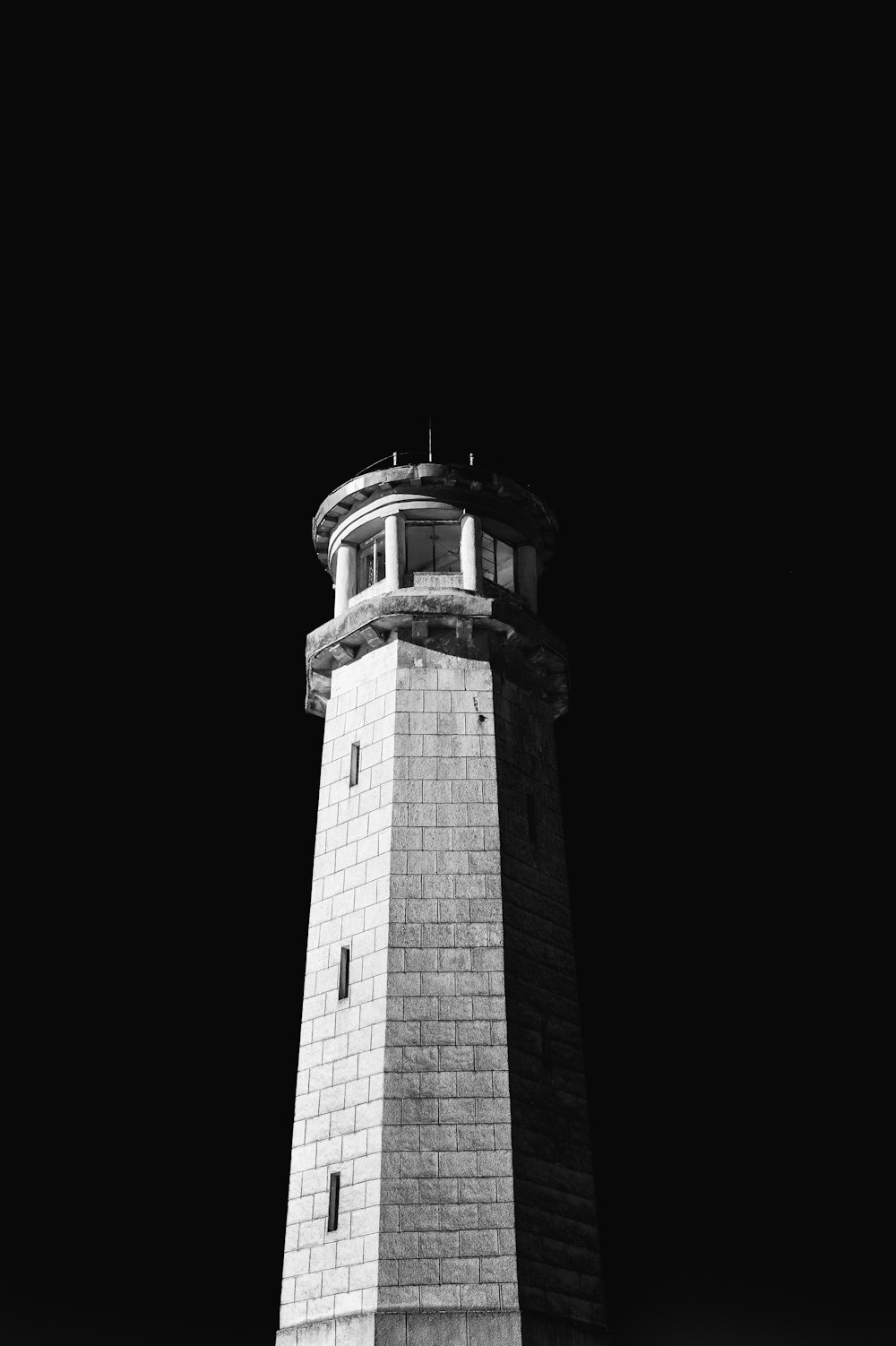 a black and white photo of a lighthouse