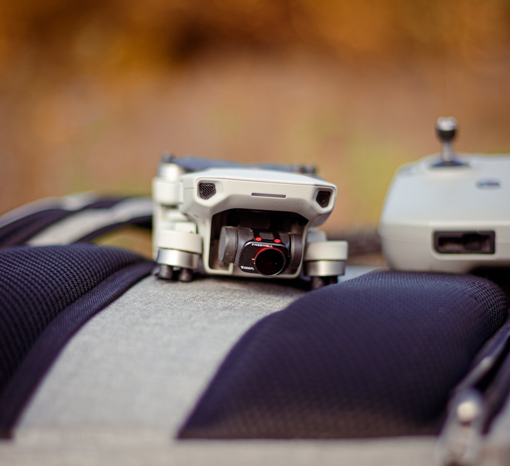 a camera sitting on top of a suitcase