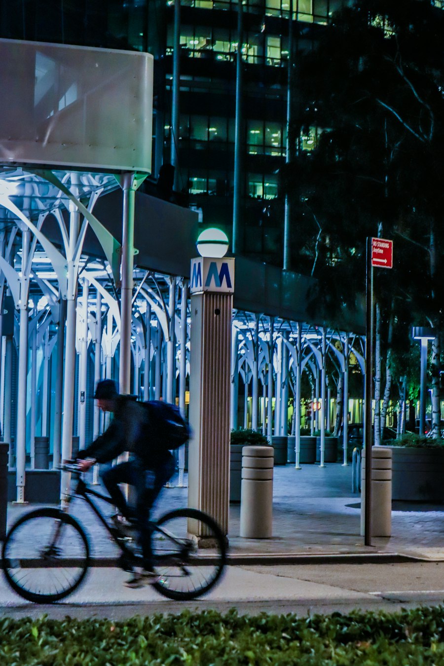 A man riding a bike down a street at night
