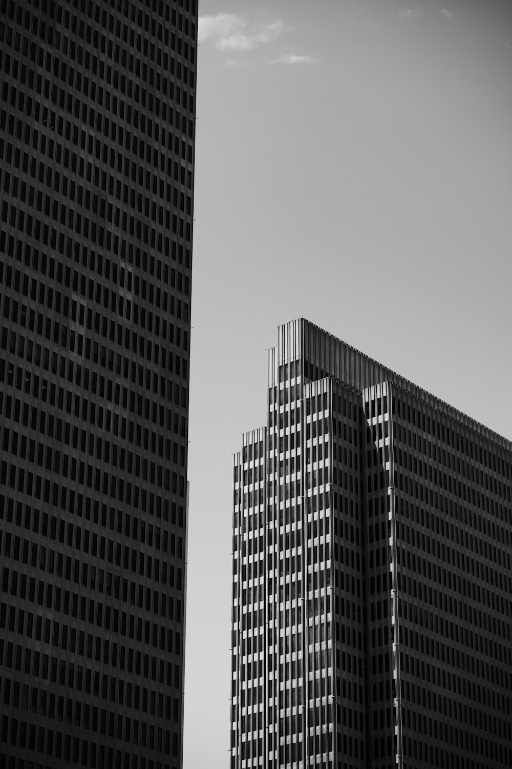 a black and white photo of two tall buildings