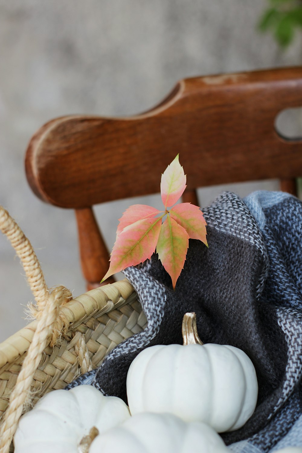 a basket filled with white and orange pumpkins